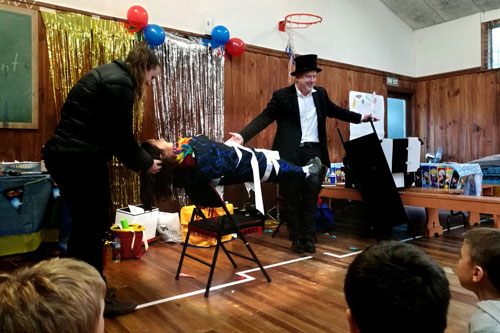 A child participating in Jimmy Marvel's floating-child illusion