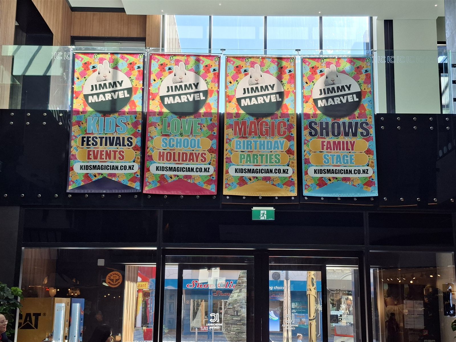 Four Jimmy Marvel hanging banners installed above an entrance at Invercargill Central